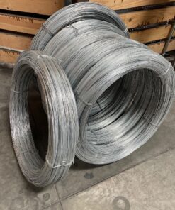 Coils of galvanized steel wire on a warehouse floor.