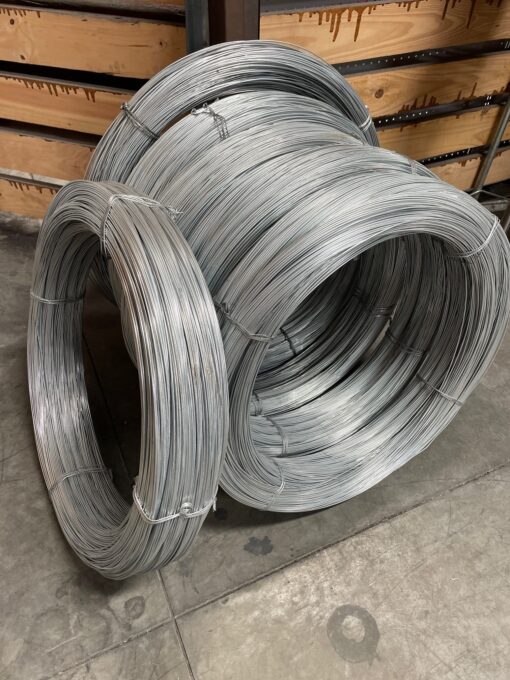 Coils of galvanized steel wire on a warehouse floor.