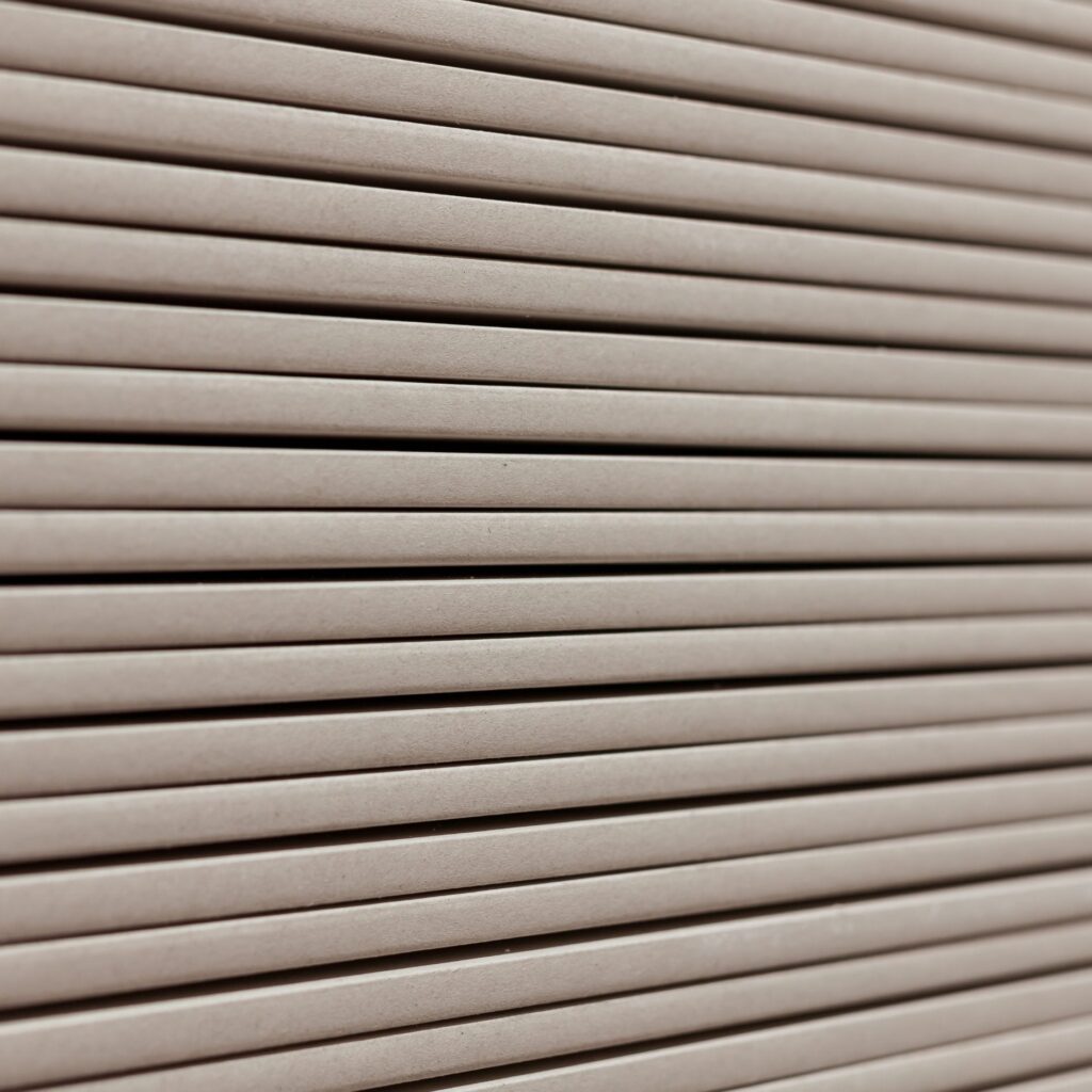 Close-up of stacked gypsum panels showcasing smooth texture and durability